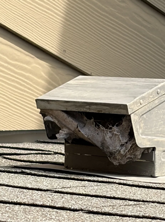 Dryer vent dense lint blockage at outside hood fire hazard before cleaning San Antonio Texas