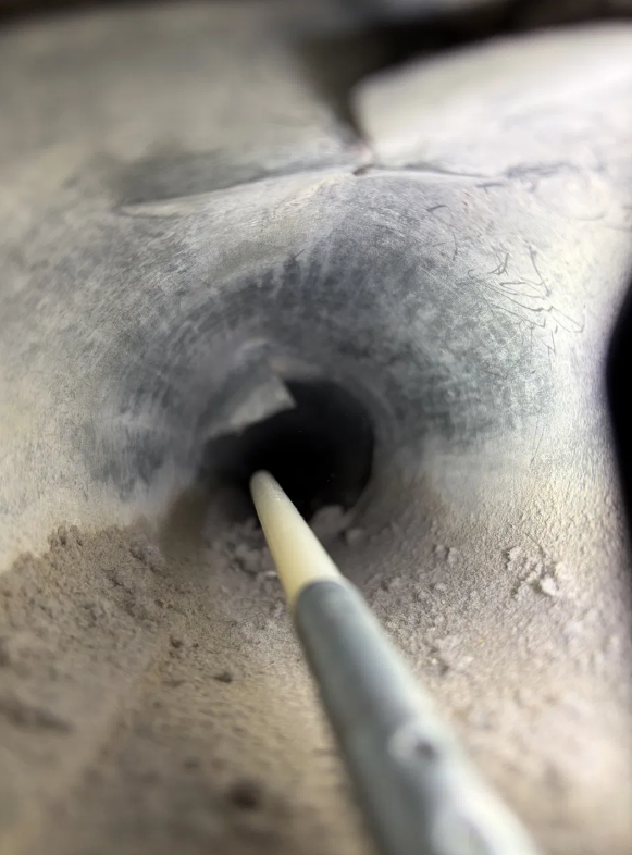 Dryer vent cleaning rod inserted into duct during professional service San Antonio Texas